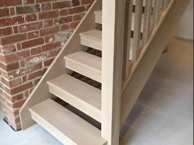 Solid oak treads on a closed-string staircase